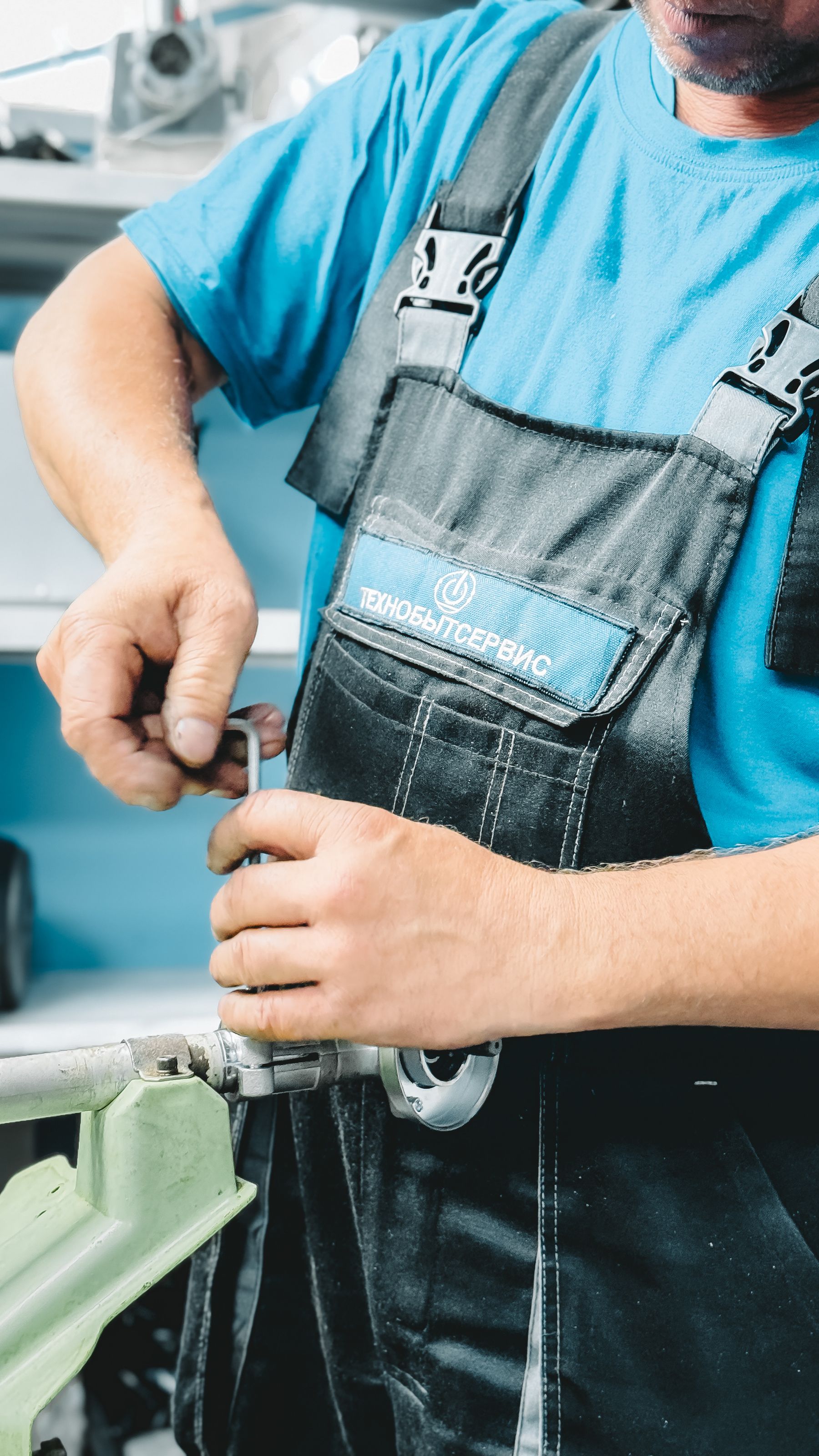 Plumber tightening a pipe with a wrench
